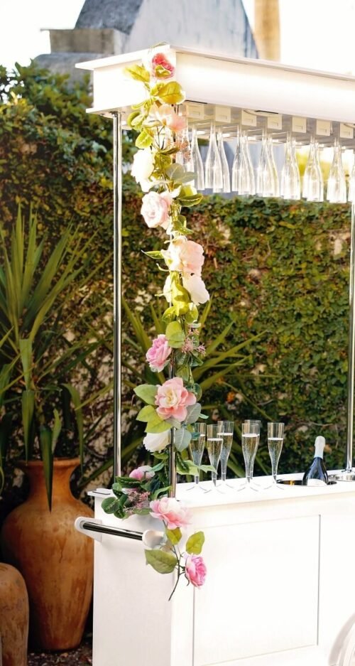 champagne cart with pink flower garland